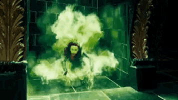 a woman is sitting on the floor in a room with green smoke coming out of her .