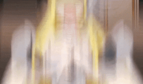 a blurry picture of a person standing in front of a wall with smoke coming out of it
