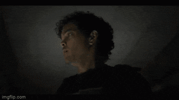 a close up of a man 's face in the dark .