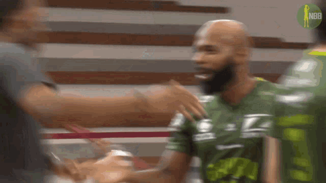 a blurry picture of a man in a green shirt that says nbr