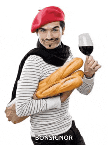 a man in a red beret is holding a glass of wine and bread