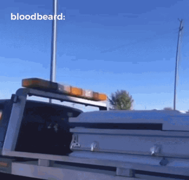 a coffin is on the back of a tow truck with the words bloodbeard written on the bottom