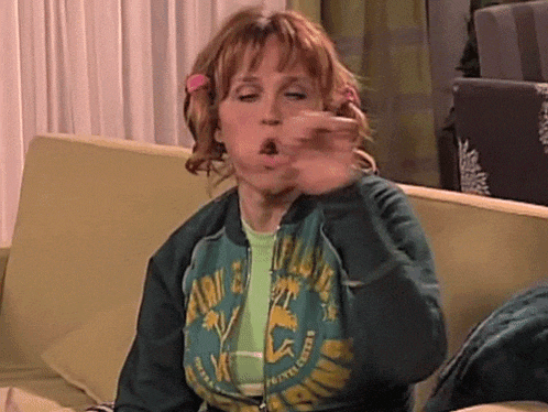 a woman is sitting on a couch wearing a green jacket that says florida