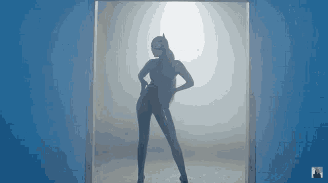 a woman in a catwoman costume is standing in a room