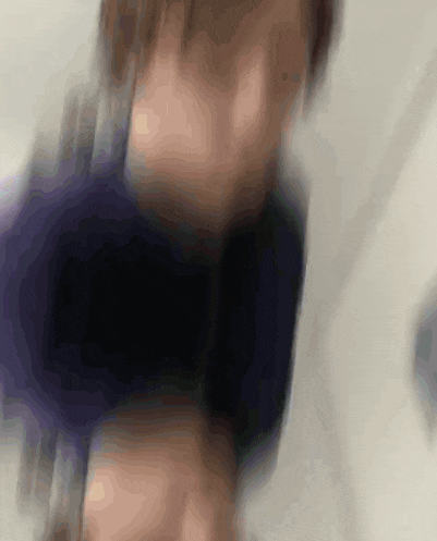 a blurry picture of a person 's face with a blue shirt on