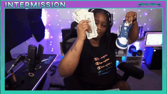 a woman holding a pair of shoes and a bunch of money with the words intermission above her
