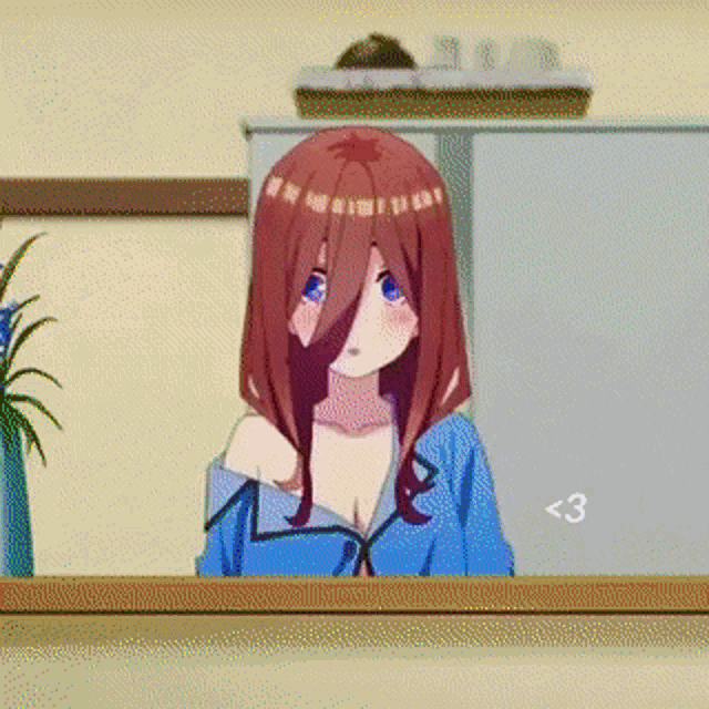 a girl with red hair and blue eyes is standing in front of a fridge .