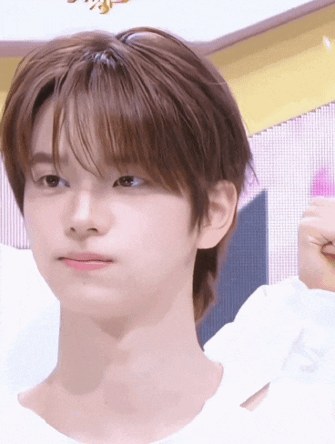 a close up of a young man 's face with brown hair