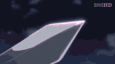 a person is holding a pink object in their hand in front of a pink light .