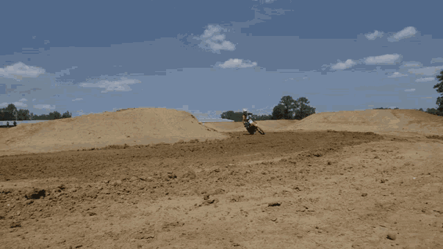 a person is riding a dirt bike on a dirt road
