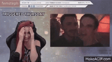 a woman with red hair is sitting in front of a screen that says triggered thursday on it .
