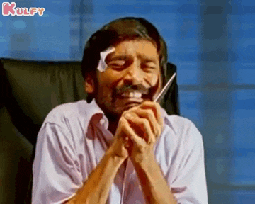 a man is sitting in a chair with a bandage on his head while talking on a cell phone .