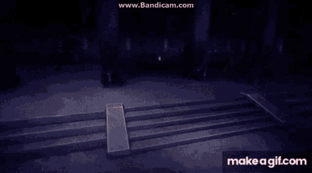 a person is standing in front of a cross in a dark room with a light coming out of it .
