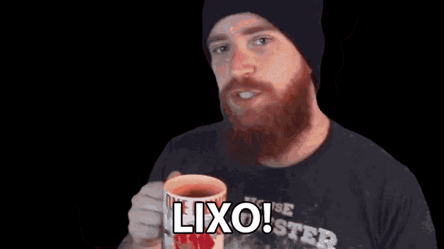 a man with a beard is holding a coffee mug that says lixo