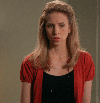 a woman wearing a red cardigan and black top