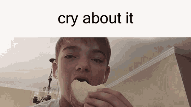 a young boy is eating a piece of bread with the caption cry about it