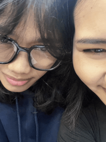a girl wearing glasses and a girl wearing a black shirt