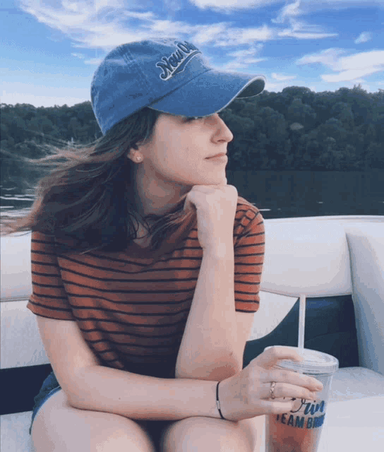 a woman wearing a blue hat that says yeah