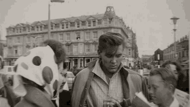 a black and white photo of a man in a jacket