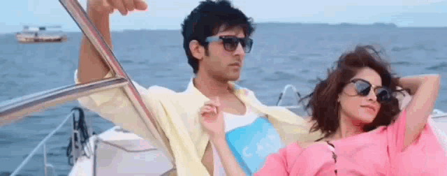 a man and a woman are on a boat in the ocean .