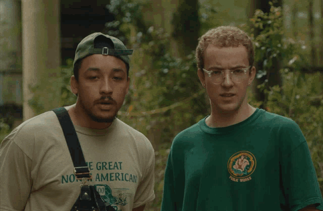 two men standing next to each other one wearing a shirt that says the great north american