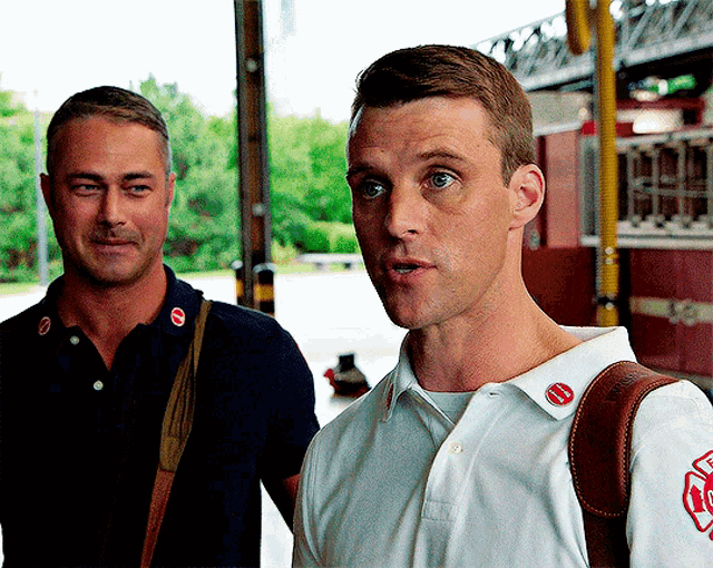 two men standing next to each other with one wearing a shirt with the number 10 on the collar