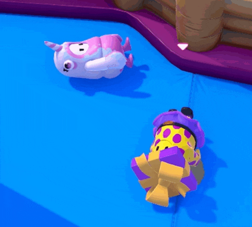 two stuffed animals laying on top of a blue mat