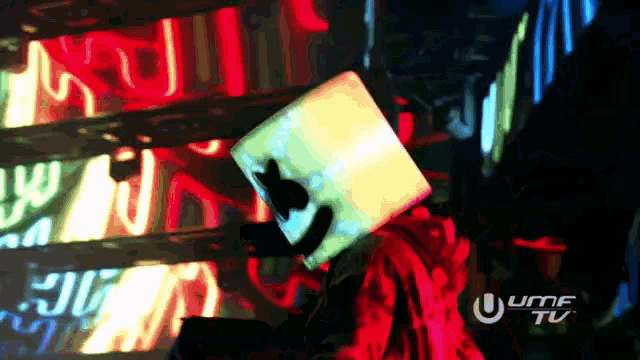 a person with a marshmallow on their head stands in front of a sign that says uhf tv