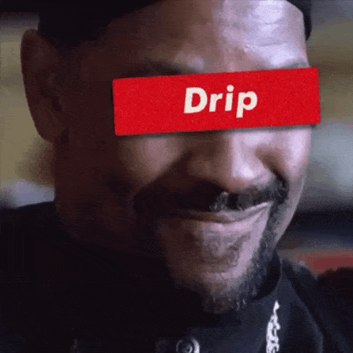 a close up of a man 's face with a red drip label on his eye