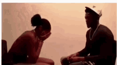 a man and a woman are sitting next to each other .