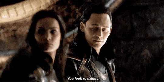 a man and a woman are standing next to each other in a dark room .