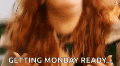 a woman with red hair is blowing a kiss and getting monday ready .