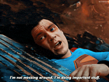 a man in a superman costume is laying down and saying i 'm not messing around
