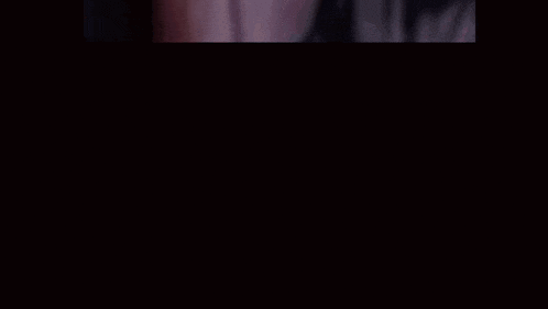 a blurry picture of a person with their hands on their face