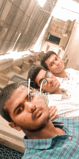 three young men are posing for a picture and the time is 01:26