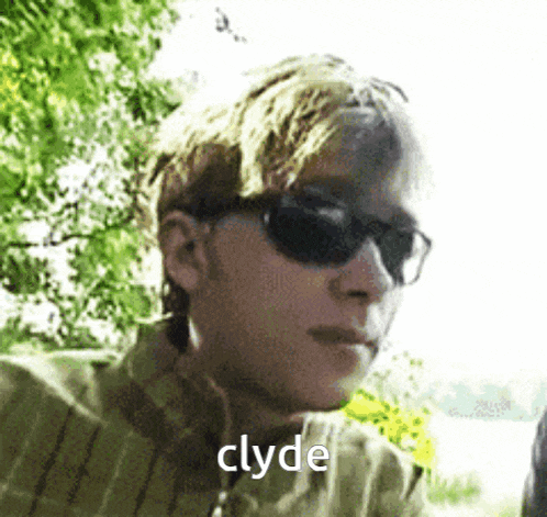 a man wearing sunglasses and a plaid shirt has the word clyde on his face .