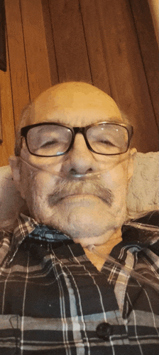 a man wearing glasses and an oxygen mask