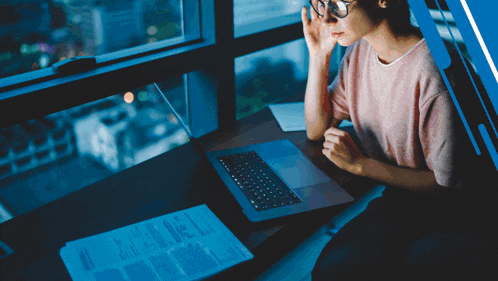 a woman sitting at a desk with a laptop and a digitaldadi logo