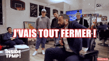 a man in a suit sits in a chair with the words j'vais tout fermer above him
