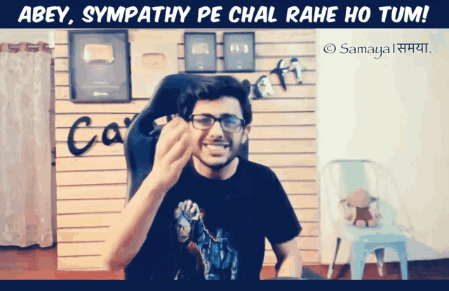 a man wearing glasses and a black shirt with the words abey sympathy pe chal rahe ho tum below him