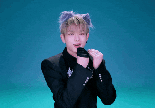 a man wearing a cat ear headband and a black jacket