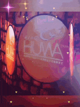 a group huma logo is projected on a wall