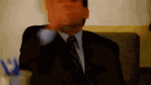 a blurry picture of a man in a suit and tie