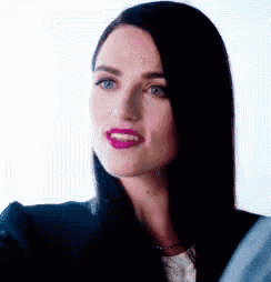 a close up of a woman 's face with purple lipstick .