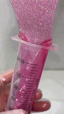a hand is holding a syringe that says 60ml
