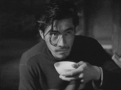 a man is holding a small white bowl in his hands
