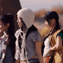 three women are standing next to each other in a line .