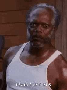 an older man with a beard is wearing a white tank top and saying `` i said 2 letters `` .