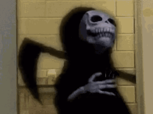 a grim reaper is standing in a doorway holding a scythe .