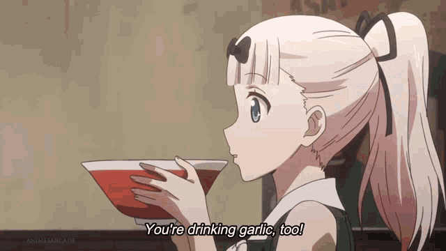a girl is drinking garlic from a bowl